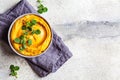 Sweet potato hummus or pumpkin dip in a gray bowl, top view