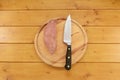 Sweet potato with a knife on a chopping board Royalty Free Stock Photo