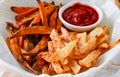 Sweet potato and potato chips and tomato sauce Royalty Free Stock Photo