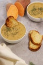 sweet potato puree soup with garlic bread on grey marble table Royalty Free Stock Photo