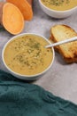 sweet potato puree soup with garlic bread on grey marble table Royalty Free Stock Photo