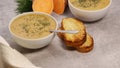 sweet potato puree soup in white bowl with garlic bread on grey marble table Royalty Free Stock Photo