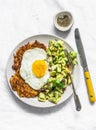 Sweet potato rostis with fried egg and avocado salsa on light background, top view Royalty Free Stock Photo