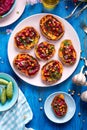 Sweet potato toast with beet hummus, grilled chickpeas, fresh parsley, nigella seeds and sunflower seeds on a plate on a table Royalty Free Stock Photo