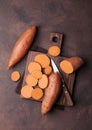 Sweet potato on wooden kitchen board from above. Royalty Free Stock Photo