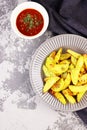 Sweet potatoes with greens and ketchup close - up on the table Royalty Free Stock Photo