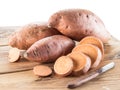 Sweet potatoes on the old wooden table.