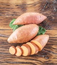 Sweet potatoes on the old wooden table. Royalty Free Stock Photo