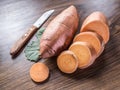 Sweet potatoes on the old wooden table Royalty Free Stock Photo
