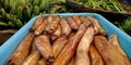 sweet potatoes into the water at container in vegetable store