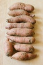 Sweet potatoes wooden background