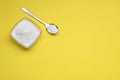 Sweet powdered fructose on yellow background, flat lay. Space for text