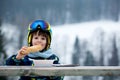 Sweet preschool child, eating soup in a restaurant on ski slope Royalty Free Stock Photo