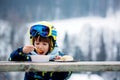 Sweet preschool child, eating soup in a restaurant on ski slope Royalty Free Stock Photo