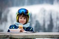 Sweet preschool child, eating soup in a restaurant on ski slope Royalty Free Stock Photo