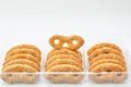 Sweet pretzels, cookies in a plastic transparent box on a white background, in a close-up, isolated, front view
