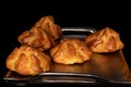 Sweet profiterole on black glass