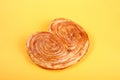 Sweet puff pastry on yellow background - Palmeras