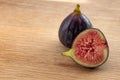 Sweet raw fruit and fresh healthy food concept theme with a closeup view of ripe figs with one fig sliced in half isolated on top Royalty Free Stock Photo