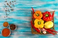 Fresh vegetables,.Sweet red, yellow, green, orange pepper in basket on wooden background. Red pepper spice and black pepper