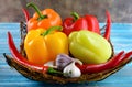 Fresh vegetables,.Sweet red, yellow, green, orange pepper in basket on wooden background. Red pepper spice and black pepper Royalty Free Stock Photo