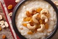sweet rice pudding with nuts and raisins in a bowl closeup. horizontal top view