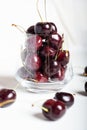 Sweet ripe cherries in glass bowl around white background. close up Royalty Free Stock Photo