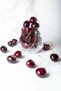 Sweet ripe cherries in glass bowl around white background Royalty Free Stock Photo