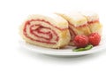 Sweet roll cake with raspberry jam and berries, isolated on a white