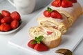 Sweet roll stuffed with strawberry and cream decorated with strawberries, powdered sugar and mint leaves Royalty Free Stock Photo