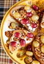 Sweet rye and wheat toasts with grape, ricotta, walnut