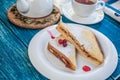 Sweet sandwiches with tea on the blue wooden table