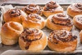 Sweet Scadinavian aromatic cinnamon rolls. Traditional homemade pastry made from butter dough. Delicious buns on baking paper.