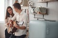 Sweet serenade. Young guitarist playing love song for his girlfriend in the kitchen Royalty Free Stock Photo