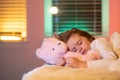 Sweet sleep. Kid sleeping with a toy teddy bear in bed. Child sleeping in bed under blanket. Kid lying on pillow, child Royalty Free Stock Photo