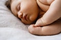 Sweet sleeping newborn baby fists in bed Royalty Free Stock Photo