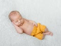 Sweet sleeping newborn boy in yellow panties