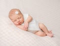 Sweet sleeping newborn girl with flower on her headband Royalty Free Stock Photo