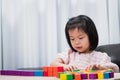 Sweet smile girl funny with wood block toys. Happy child hobby in home or school. Kindergarten pupil learning and playing. Royalty Free Stock Photo