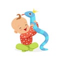 Sweet smiling baby playing with toy snake, colorful cartoon character vector Illustration Royalty Free Stock Photo