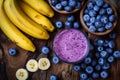 Sweet smoothie or milkshake with banana and blueberries. Purple colorful fruit juice milkshake. Diet smoothie with yogurt or milk Royalty Free Stock Photo