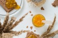 Sweet snack or breakfast with orange jam in glass jar, rye crisp bread Swedish crackers with spread orange jam Royalty Free Stock Photo