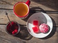 Sweet snack with cranberry marshmallow and marmalade, tea in a large ceramic mug and a glass jar with cherry jam and a Royalty Free Stock Photo