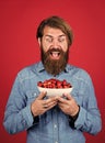 Sweet and soft. man holding ripe sweet cherries. eating ripe berries in early summer. Fresh red sour cherries harvest in Royalty Free Stock Photo