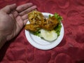 Sweet and sour fried chicken in a white container with cucumber slices and green lettuce Royalty Free Stock Photo