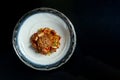 Sweet and sour glass noodles with pork, vegetables and onions, served in a white bowl. Wok noodles. Isolated over black background Royalty Free Stock Photo