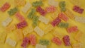 Sweet sour gummy bears as candy on yellow background Royalty Free Stock Photo