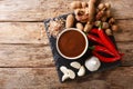 Sweet and sour spicy tamarind sauce with ingredients close-up on a table. horizontal top view