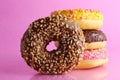 Sweet Still Life Donut Berliner Close-up At The Back Lie A Stack Of Three Doughnut Chocolate Pink Yellow On A Bright Pink Fuchsia