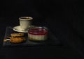 sweet strawberry dessert and two brown butter cookie, on background aromatic black coffee in a cup of creamy Royalty Free Stock Photo